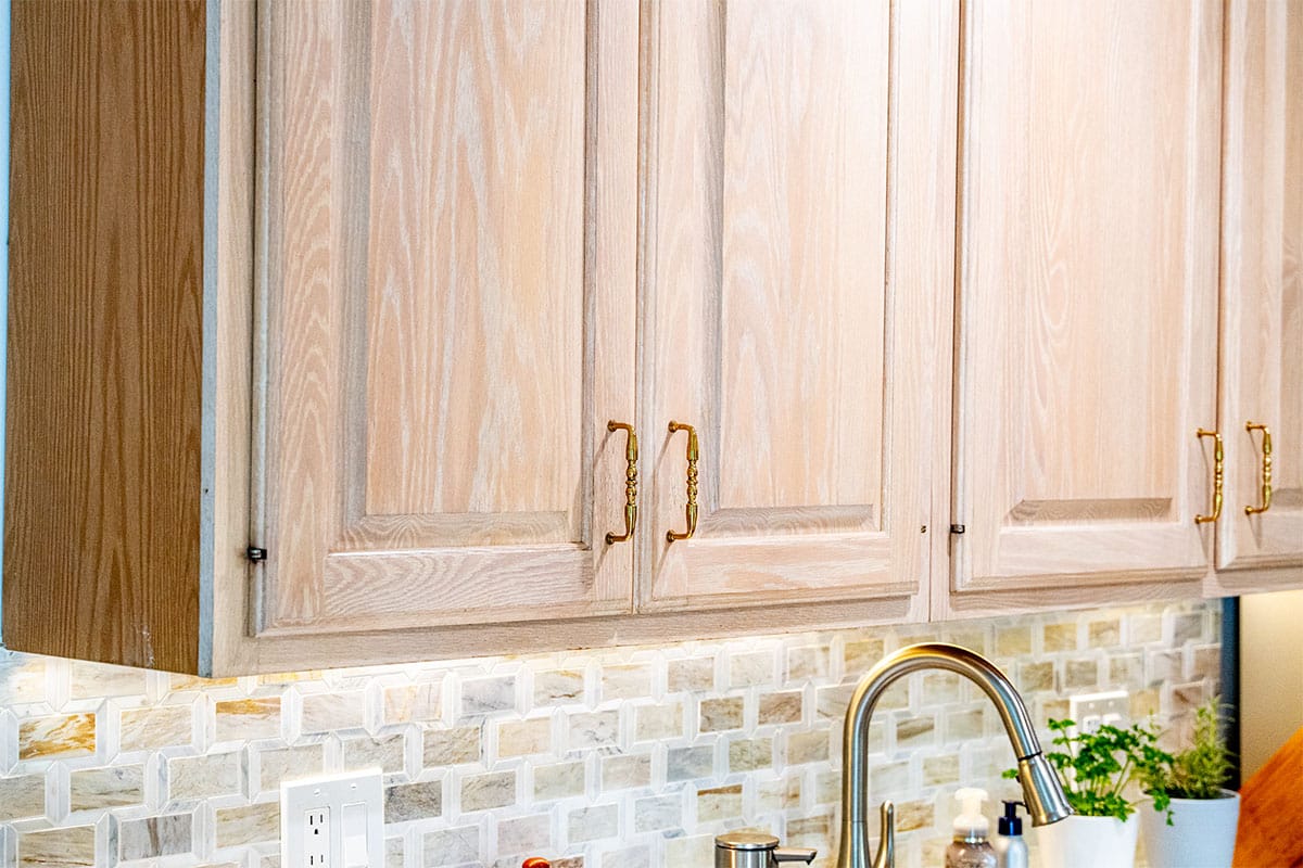 Closeup on gold handles for wooden cabinets