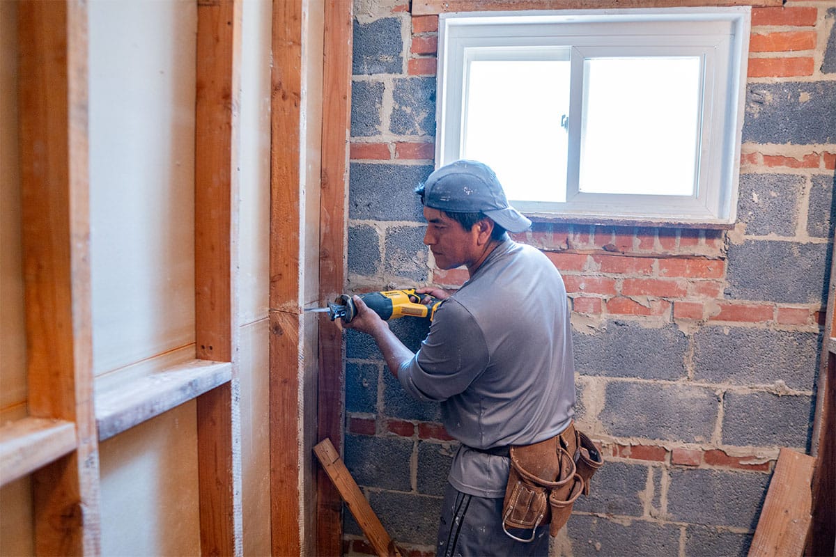 HCA Construction worker removing old walls inside a Silver Spring bathroom