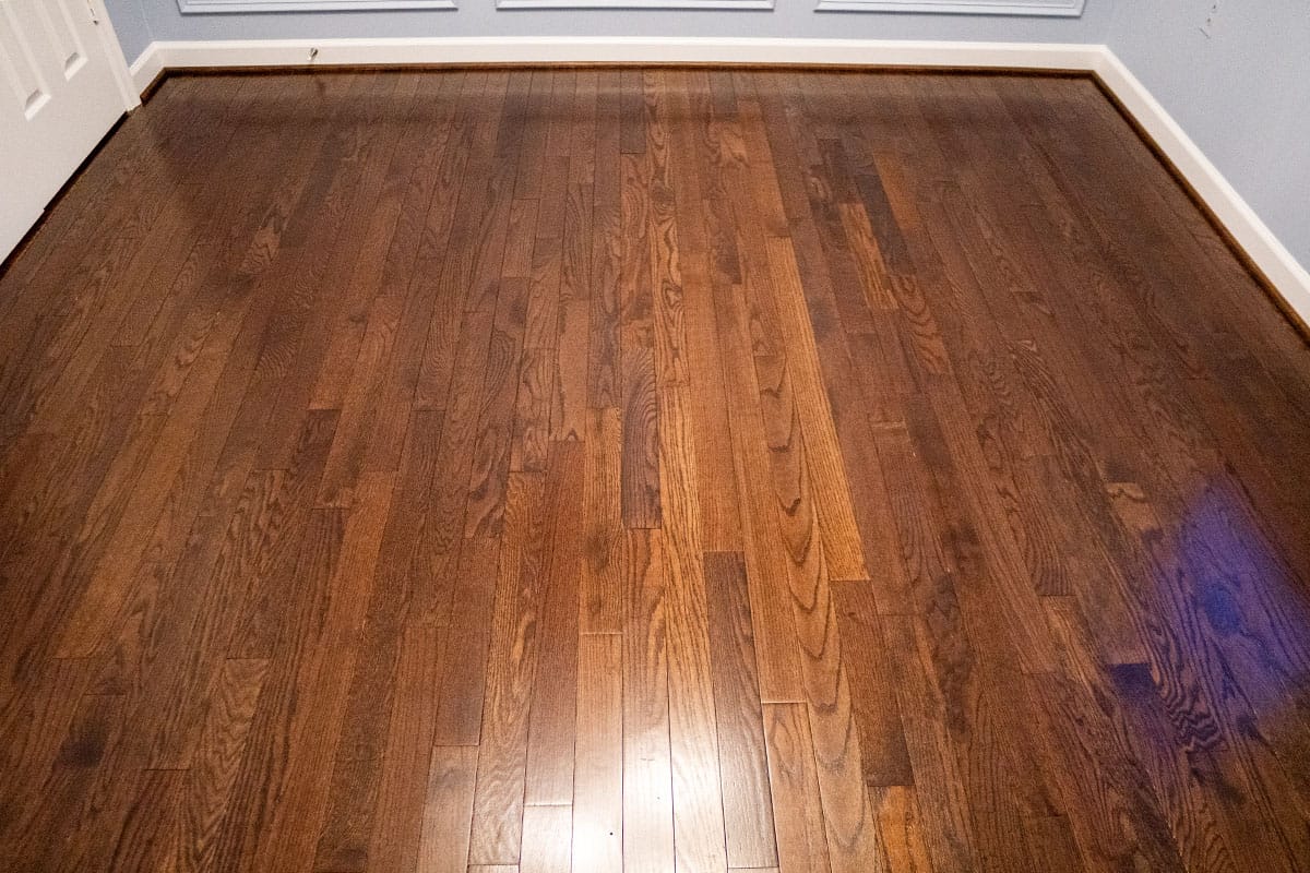Wide view of new wooden flooring installed in a guest bedroom in Derwood